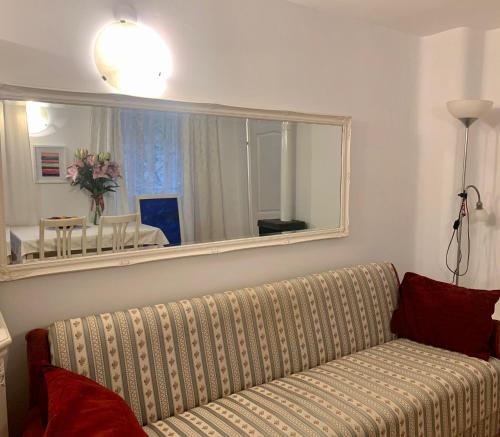 a living room with a couch and a large mirror at Apartment St. Marko in Zagreb