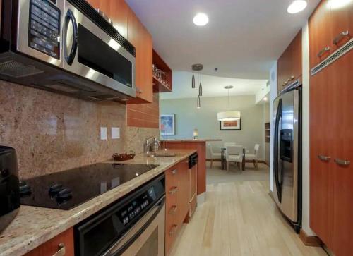 a kitchen with a sink and a microwave at Brickell Apt Free Parking 4 People Pool Ocean View in Miami