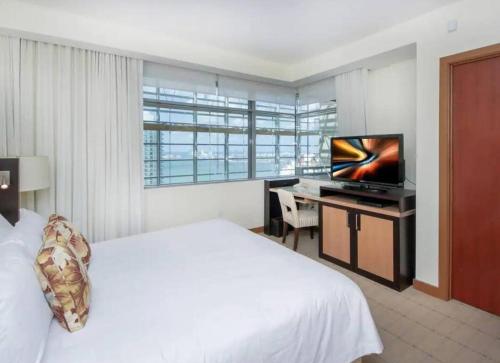 a hotel room with a bed and a television at Brickell Apt Free Parking 4 People Pool Ocean View in Miami
