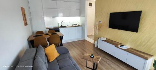 a living room with a couch and a table and a kitchen at VIP Apartment in Jagodina
