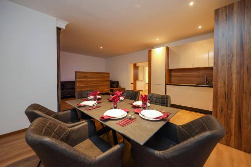 a dining room with a table and chairs at Hotel Apartments Ardi & Lala in Peje