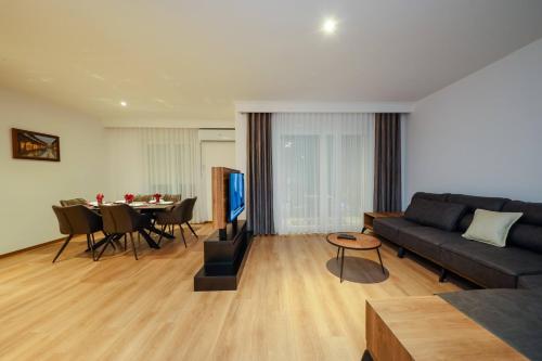 a living room with a couch and a table at Hotel Apartments Ardi & Lala in Peje