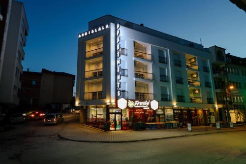 a tall building with a store in front of it at Hotel Apartments Ardi & Lala in Peje