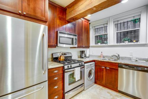 a kitchen with wooden cabinets and a stainless steel refrigerator at World Cup Getaway! Walkable Dtwn Seattle Condo in Seattle