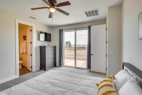 a bedroom with a bed and a ceiling fan at Modern Fort Mohave Home with Patio and Grill! in Fort Mohave