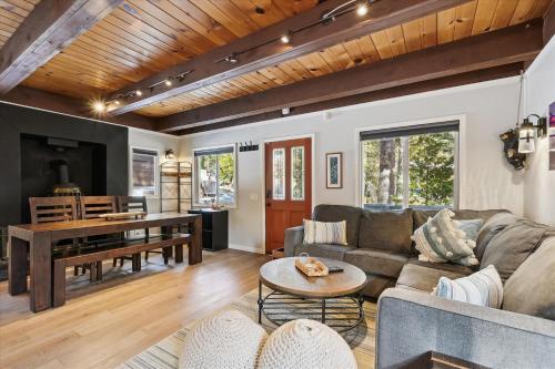 a living room with a couch and a table at Cobalt Cabin by Tahoe Getaways - Beautifully Remodeled Pet Friendly 3 BR with Hot Tub & EV in Carnelian Bay