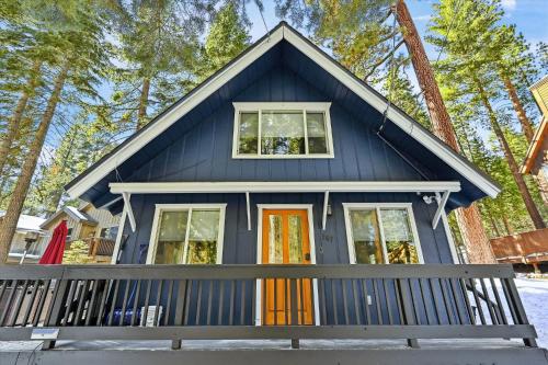 a blue tiny house with colorful doors at Cobalt Cabin by Tahoe Getaways - Beautifully Remodeled Pet Friendly 3 BR with Hot Tub & EV in Carnelian Bay
