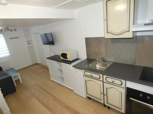 a kitchen with a sink and a counter top at Les Studios Parfaitement Imparfaits - Lens Louvre-Bollaert in Lens