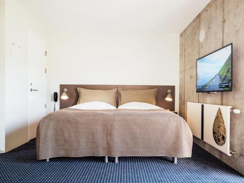 Postel nebo postele na pokoji v ubytování Hotel Føroyar