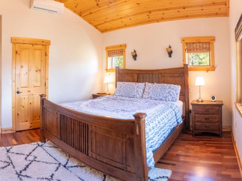 a bedroom with a large wooden bed in a room at Coyote Run Retreat by Tahoe Getaways - 3BR Pet Friendly with HOA Amenities, Minutes to Downtown Truckee & Northstar Resort! in Truckee