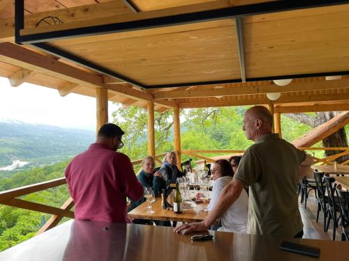 a group of people sitting at a table at a bar at Sad Meli Wines in Ambrolauri