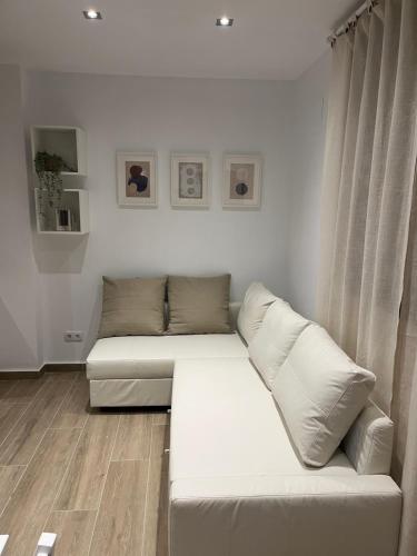a living room with a white couch in a room at CASA MARTÍN in Hornachuelos