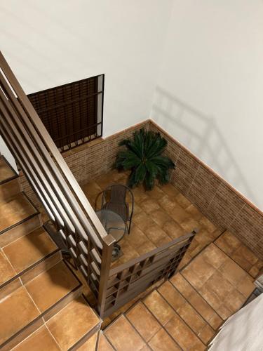 an overhead view of a staircase with a table and a plant at CASA MARTÍN in Hornachuelos
