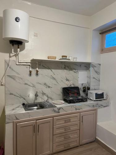 a kitchen with a sink and a counter top at Appartement au centre ville de fès in Fez