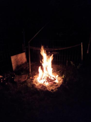 a fire burns in a field at night at Apartament Strzyżowiec 80 in Czernica
