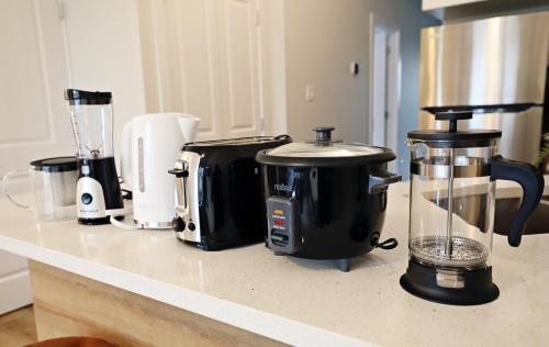 a kitchen counter with several appliances on a counter top at Central 5 Bedroom, AC, Rogers, Commonwealth, EXPO in Edmonton
