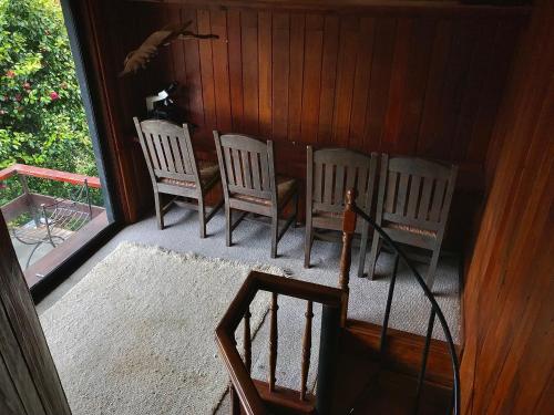 a porch with four chairs and a table at Valdivia Base Camp-Estudio Privado in Valdivia