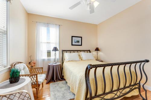 a bedroom with a bed and a chair at Seabreeze Serenity in Wilmington