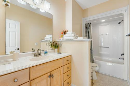 a bathroom with a sink and a toilet and a mirror at Seabreeze Serenity in Wilmington