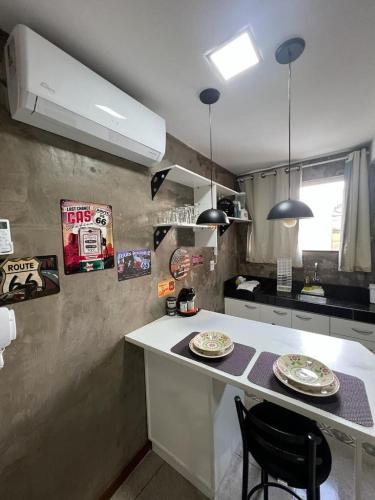 a kitchen with a counter with two plates on it at STUDIO 304 | WIFI 600MB | RESIDENCIAL JC, um lugar para ficar. in Belém