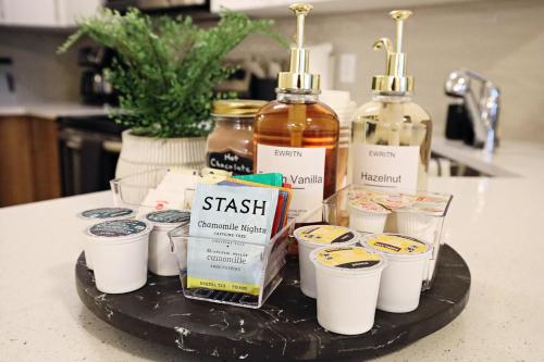 a tray with cups and bottles of alcohol on a counter at Central 5 Bedroom, AC, Rogers, Commonwealth, EXPO in Edmonton