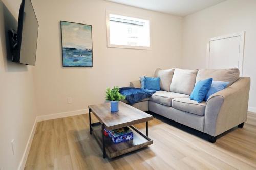 a living room with a couch and a table at Central Suite King Beds,Long Stays,Disney+ in Edmonton