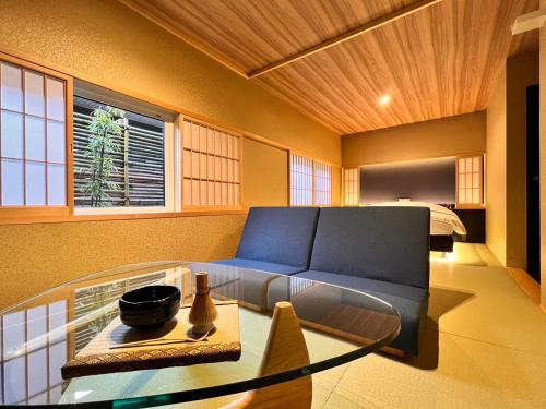 a living room with a couch and a glass table at HOTEL ZEN-Adult Only in Hirosaki