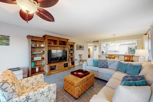 a living room with a couch and a tv at Regency Towers W 101 in Pensacola Beach