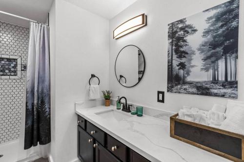 a white bathroom with a sink and a mirror at Pacific NW Gem w/Hot-tub 15 minutes Airport. in Auburn