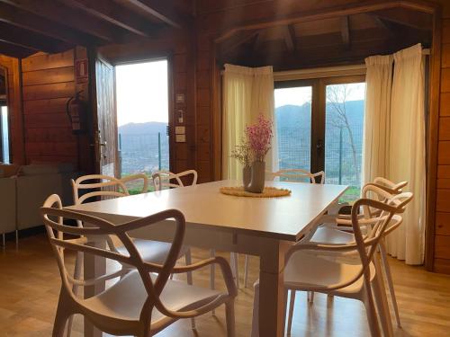 a dining room with a table and chairs and windows at La Casa del Valle in Santa Cruz de Tenerife