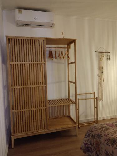 a wooden book shelf in a room with a bed at Casa Hurtere in Horta