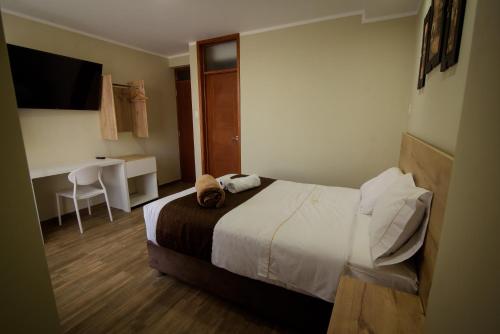 Llit o llits en una habitació de Hotel VILLA LUNA