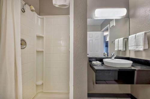 a bathroom with a sink and a mirror at Motel 6-Oshkosh, WI in Oshkosh