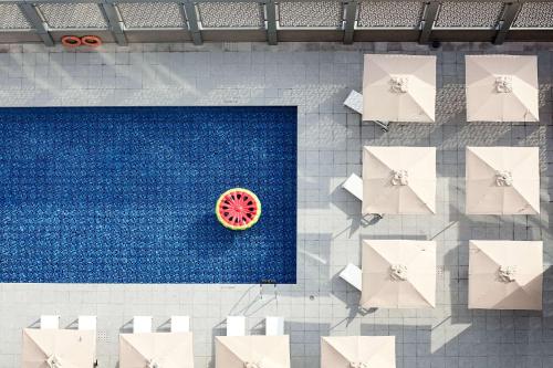 an overhead view of a pool with a slice of watermelon at Rove City Centre, Deira in Dubai