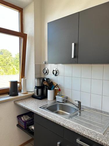 a kitchen counter with a sink and a window at Wunderschönes Appartement Nahe der Berge in Bruckmühl
