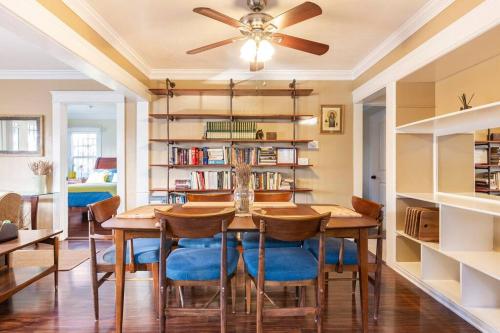 a dining room with a table and chairs and a book shelf at Charming Los Angeles Craftsman-Cottage House in Los Angeles