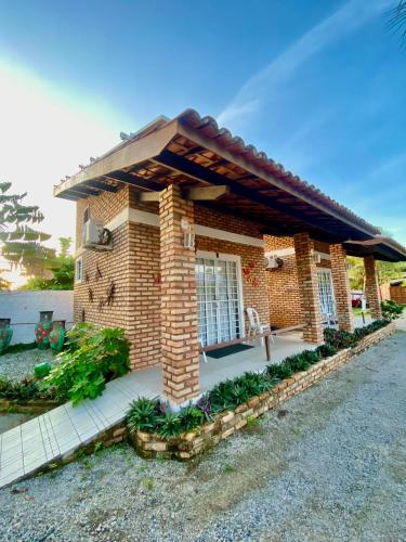 a small brick house with a roof at Chacara do Alemao in Flecheiras