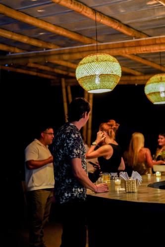 a group of people standing around a bar at Cannatel Exclusive Hotel in Armenia