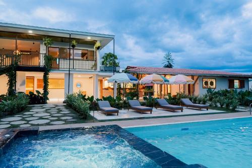 a house with a swimming pool in front of a house at Cannatel Exclusive Hotel in La Tebaida