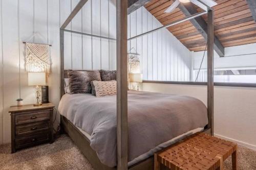 a bedroom with a canopy bed with a wooden ceiling at Epic Condo walk to Canyon Lodge in Mammoth Lakes