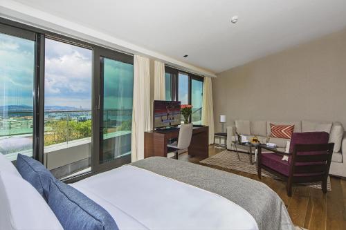 a hotel room with a bed and a desk and windows at Arts Hotel Istanbul Harbiye - Special Class in Istanbul