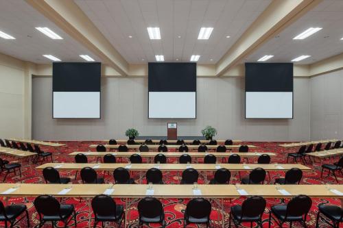 a large conference room with tables and chairs at Holiday Inn Des Moines-Airport Conf Center by IHG in Des Moines
