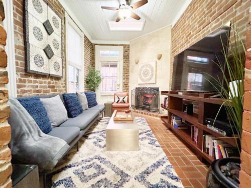 a living room with a couch and a fireplace at The Lyons House - Luxe Historical Home - Parking Included in Savannah