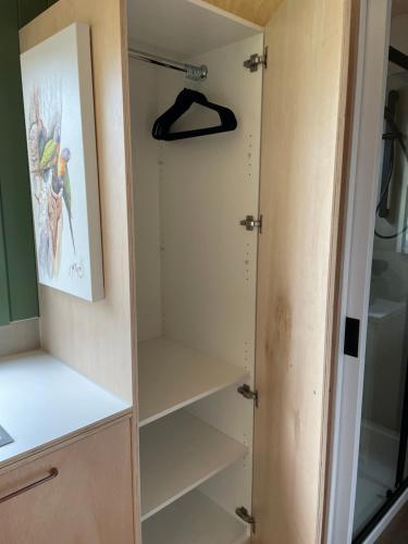 a cupboard in a kitchen with a door open at Marlo Hideaway in Marlo