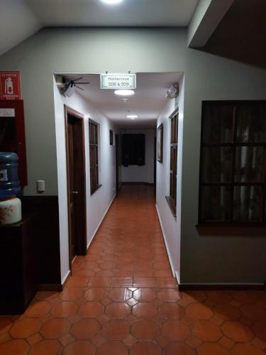 an empty hallway with a sign on the wall at HOTEL en el CENTRO HISTORICO in Cuenca