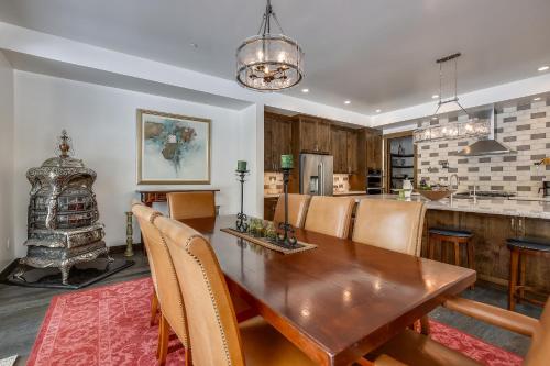 a kitchen and dining room with a wooden table and chairs at Allure at Schaffer's Mill by Tahoe Getaways - 4BR Pet-Friendly Home w Private Hot Tub & Air Conditioning! in Truckee