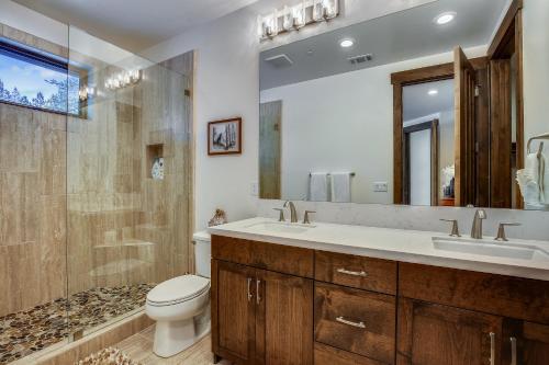 a bathroom with a toilet and a sink and a shower at Allure at Schaffer's Mill by Tahoe Getaways - 4BR Pet-Friendly Home w Private Hot Tub & Air Conditioning! in Truckee
