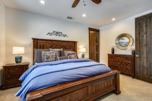 a bedroom with a large wooden bed and a dresser at Allure at Schaffer's Mill by Tahoe Getaways - 4BR Pet-Friendly Home w Private Hot Tub & Air Conditioning! in Truckee