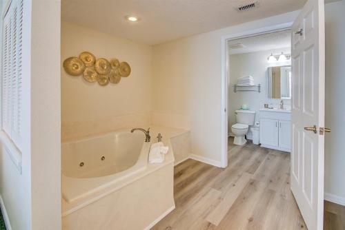 a bathroom with a bath tub and a toilet at Unit 2224 Ocean Walk - 3 Bedroom Ocean Front in Daytona Beach