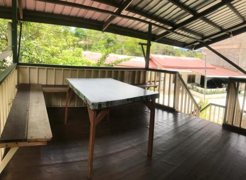 a ping pong table on a porch with a roof at Noungan Farm Homestay in Penampang